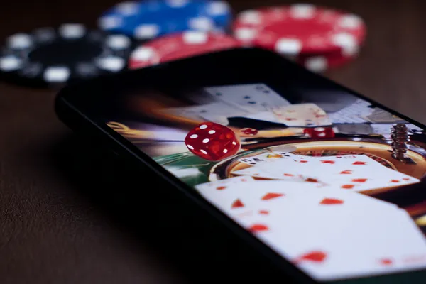 A professional dealer in a tuxedo greeting players at the roulette table, symbolizing the authentic live casino feel at 21GAME.